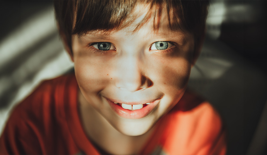 Niño con la luz del sol en la cara.