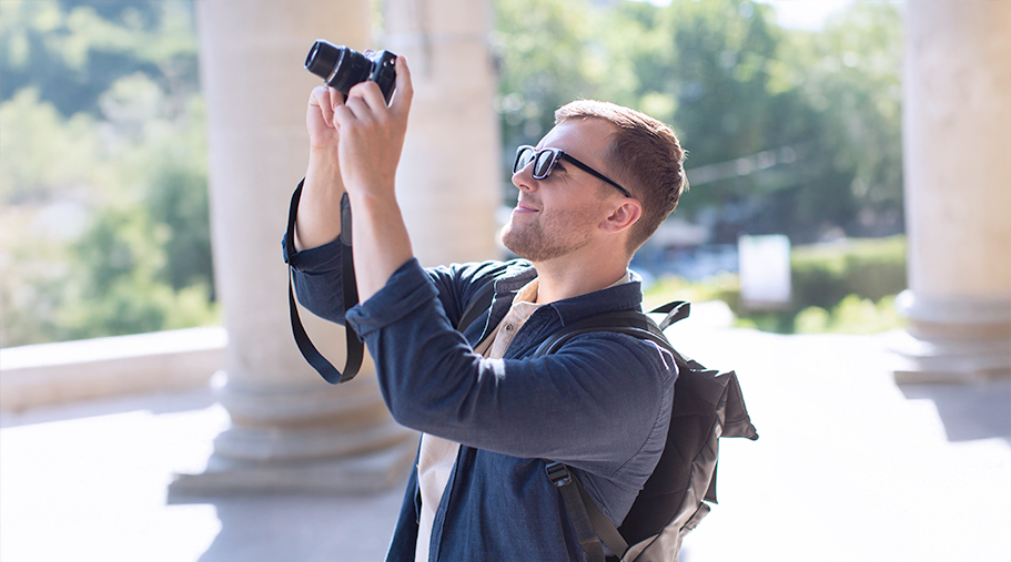 Joven turista sacando fotos con gafas de sol 
